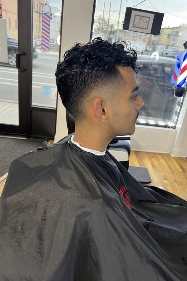 Curly fade haircut at Masih.