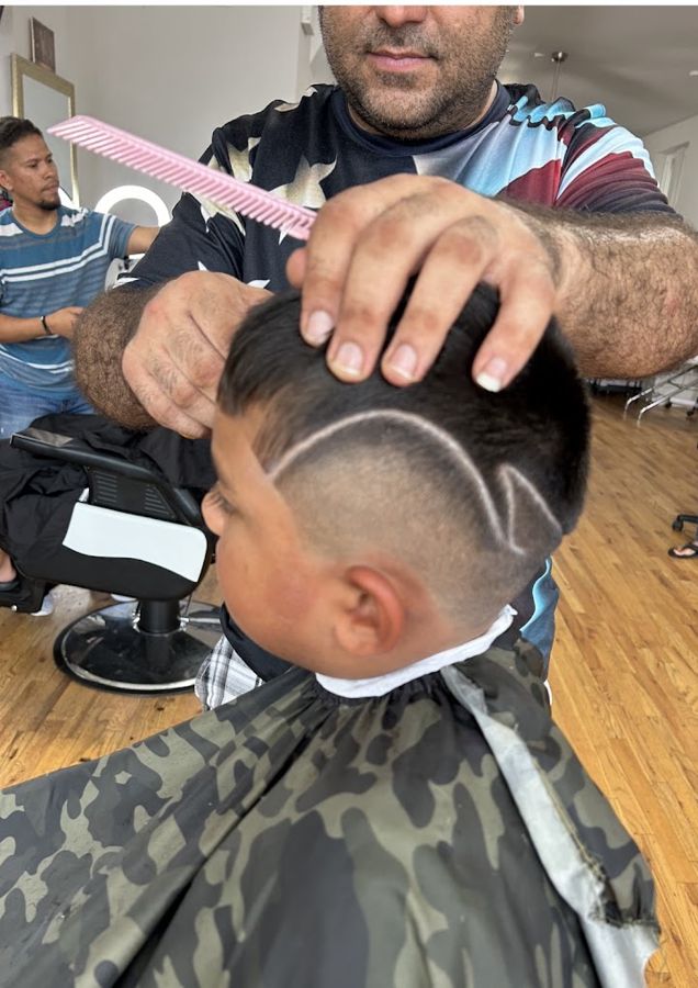 Kid getting a fresh shaved design haircut at Masih.